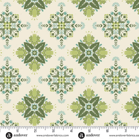 A repeating fabric pattern featuring a bold, symmetrical folk art medallion design with intricate floral and leaf motifs in soft sage, teal, and dark green on a warm cream background. Ruler at the bottom for scale.