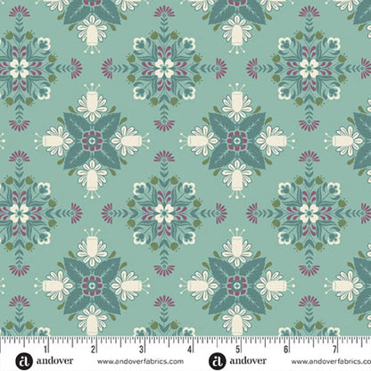 A repeating fabric pattern featuring a bold, symmetrical folk art medallion design with intricate floral and leaf motifs in dark teal, purple, olive, and cream on a soft teal-blue background. Ruler at the bottom for scale.