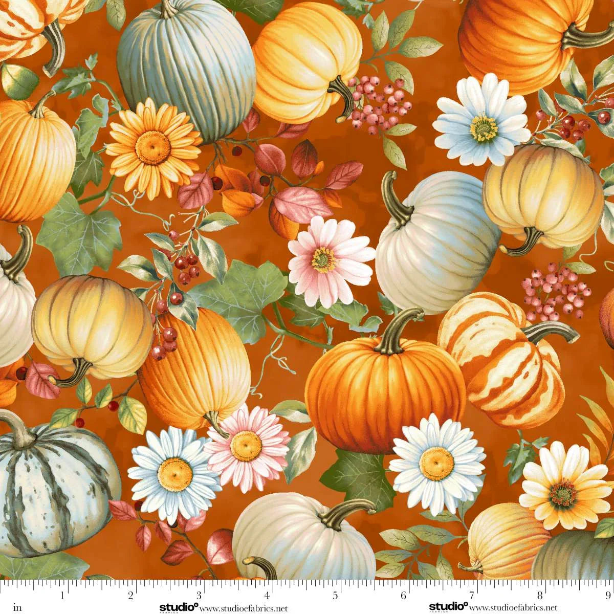 Pattern of pumpkins and flowers on an orange background. Ruler at the bottom for scale.