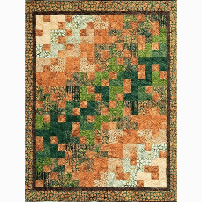 This Ambling Quilt sample features simple patchwork squares and rectangles in a colorful brown, orange, and green gradient.