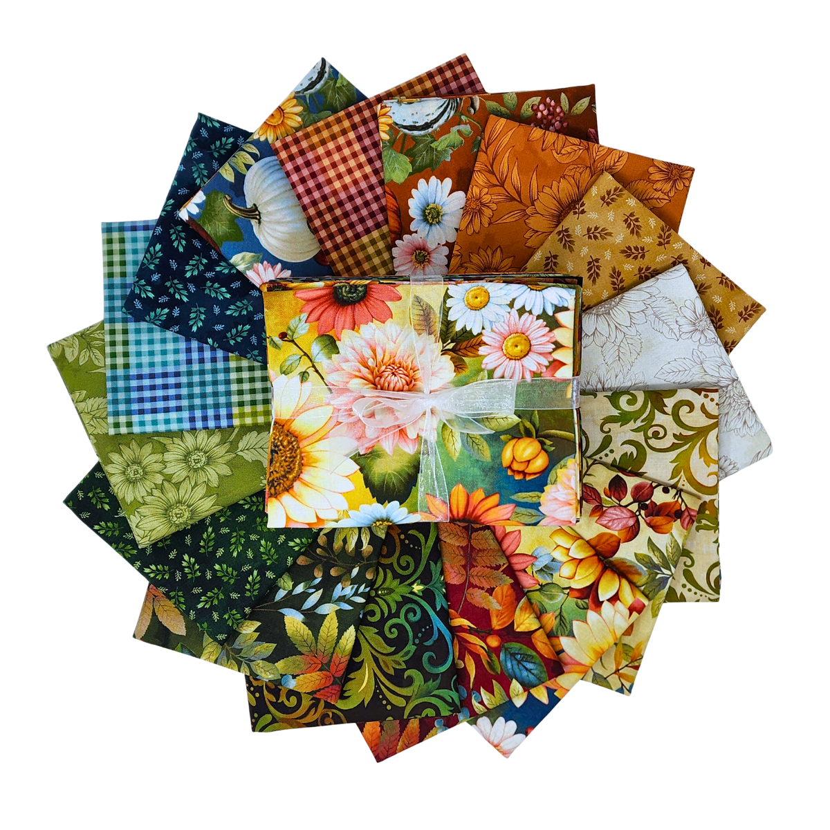 A circular arrangement of fabric squares in assorted prints, including florals, gingham, pumpkins, and leaves, rendered in a palette of beige, blue, gold, green, teal, red, and orange. 