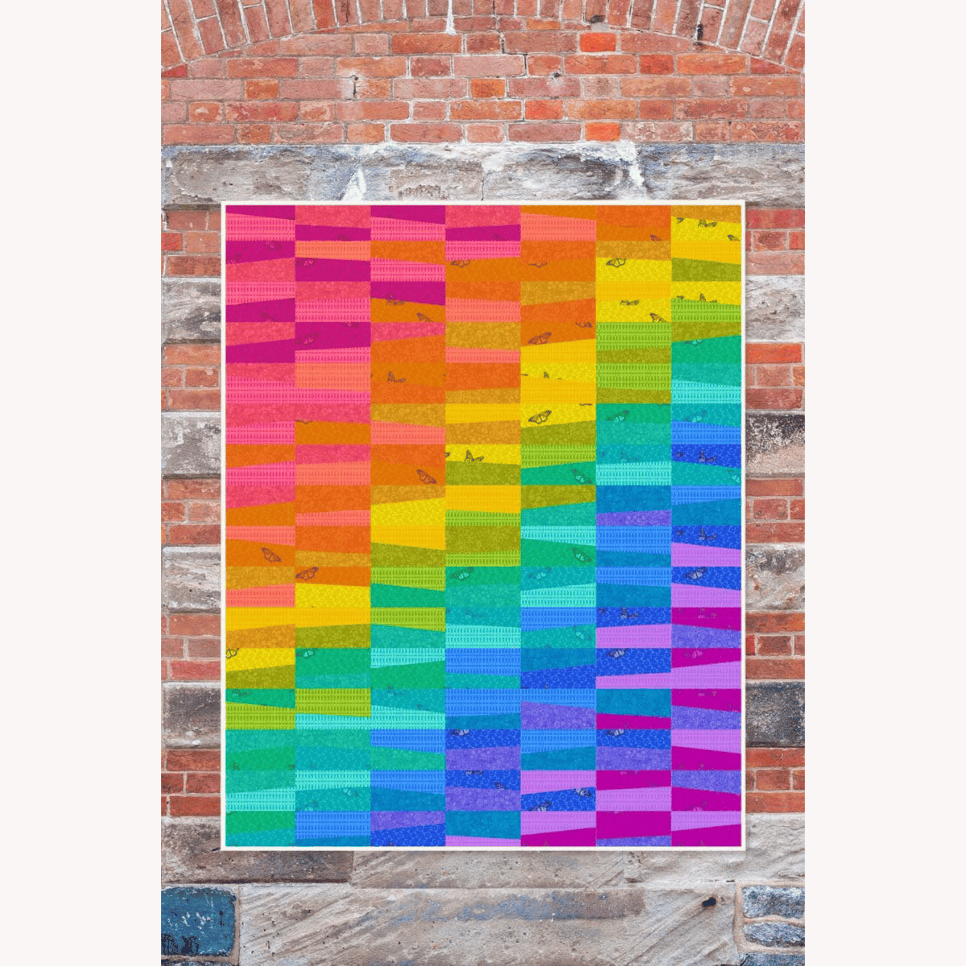 The Cobblestone Quilt Pattern makes a fun, vibrant quilt perfect for a beginning quiltmaker or anyone who wants a quick throw-size project. The rainbow shift of colors allows for a scrappy look that can be arranged in any way you choose. And the butterfly prints add just the right touch of whimsy!