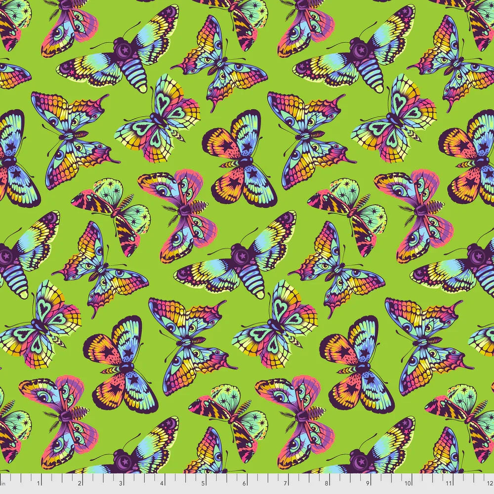 Pattern of colorful butterflies on a green background with a ruler for scale