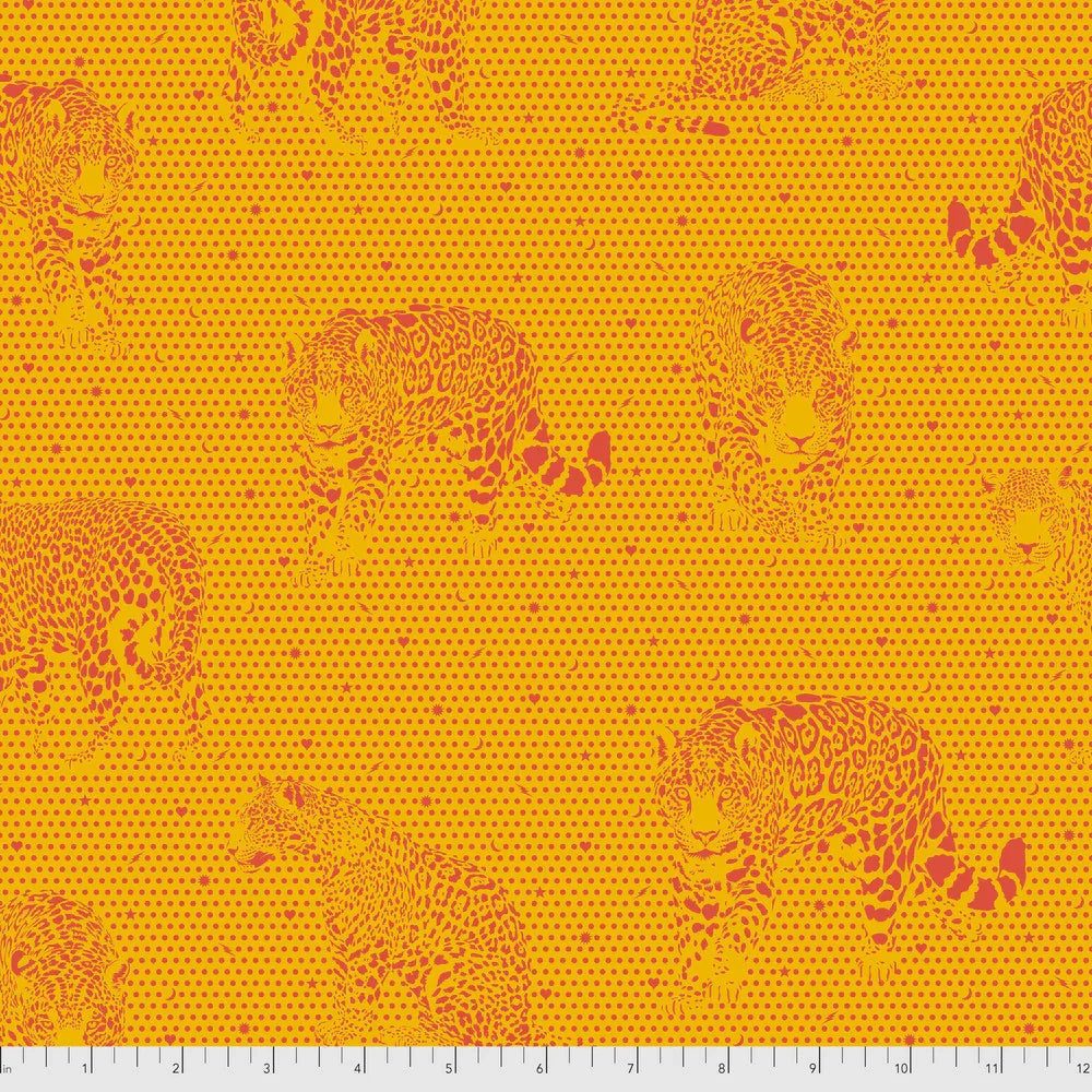 Pattern of orange jaguars on a yellow background with a ruler for scale