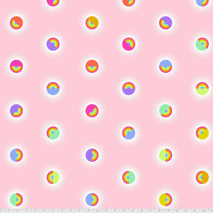Pattern of colorful rainbow circles on a pink background with a ruler for scale