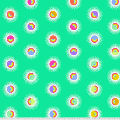 Pattern of colorful rainbow circles on a turquoise background with a ruler for scale
