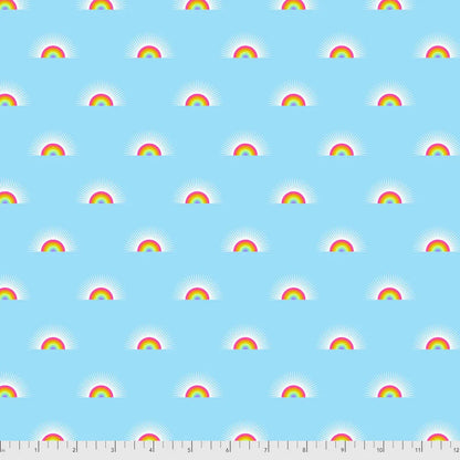 Pattern of small rainbows on a blue background with a ruler for scale.