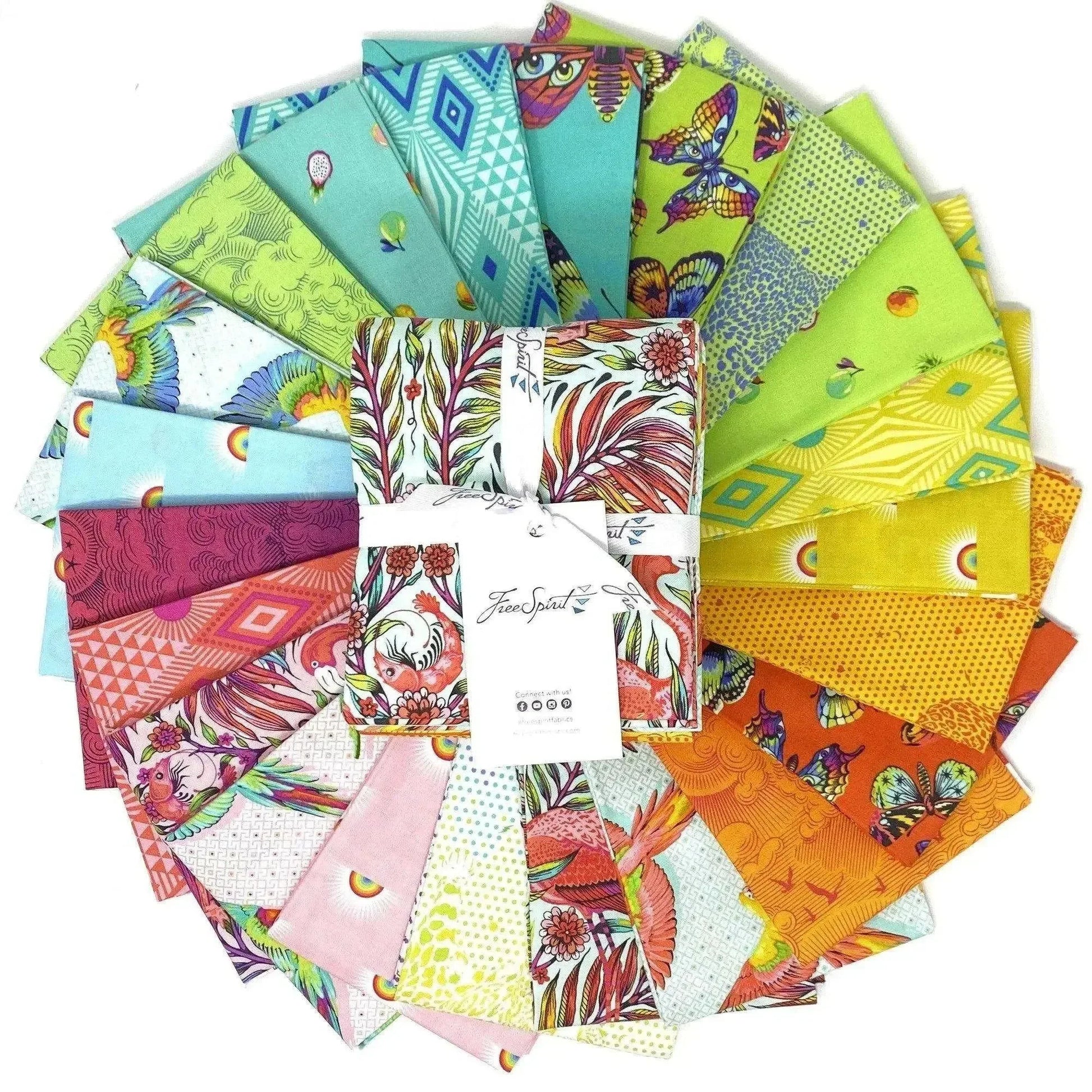 Collection of colorful fabric squares arranged in a circle with a fat quarter bundle in the center