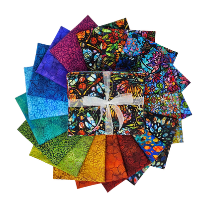Circular arrangement of colorful fabric swatches featuring stained-glass floral designs with a bundle tied with a white ribbon in the center.