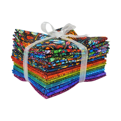 A stack of colorful fabric swatches featuring stained-glass floral designs tied with a white ribbon.