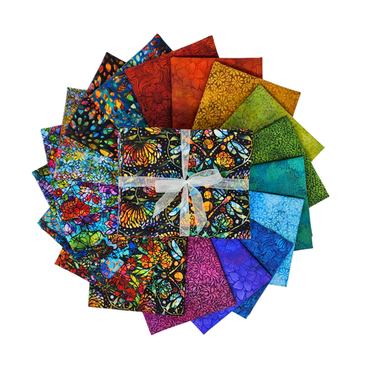 Circular arrangement of colorful fabric swatches featuring stained-glass floral designs with a bundle tied with a white ribbon in the center.