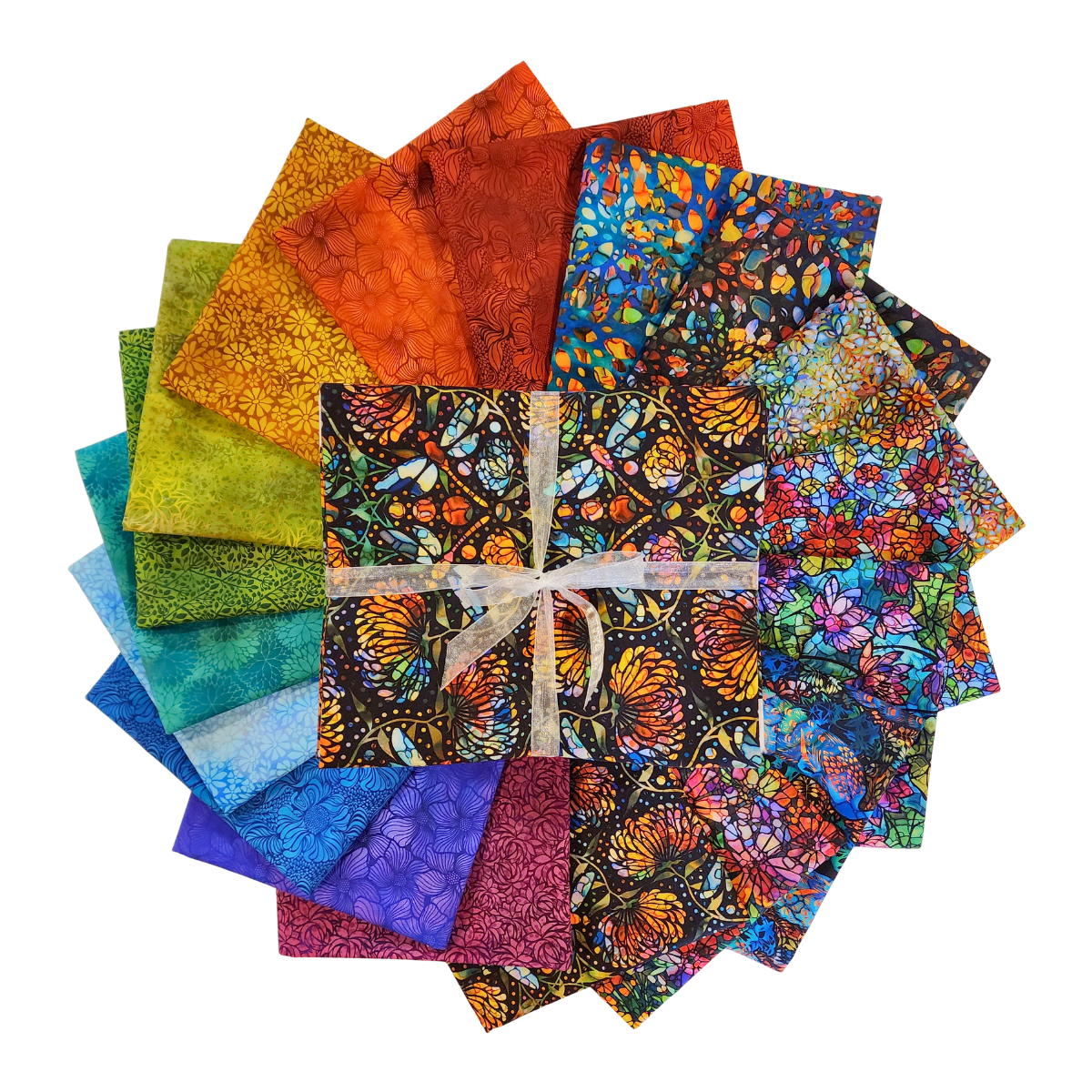Circular arrangement of colorful fabric swatches featuring stained-glass floral designs with a bundle tied with a white ribbon in the center.