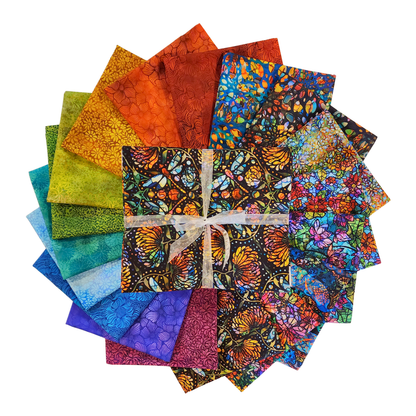 Circular arrangement of colorful fabric swatches featuring stained-glass floral designs with a bundle tied with a white ribbon in the center.