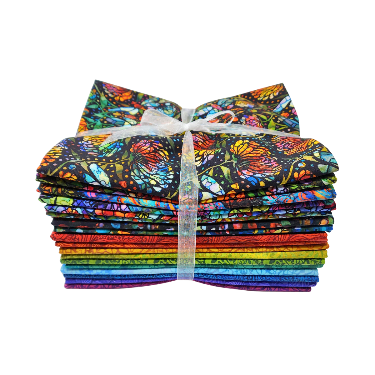 A stack of colorful fabric swatches featuring stained-glass floral designs tied with a white ribbon.