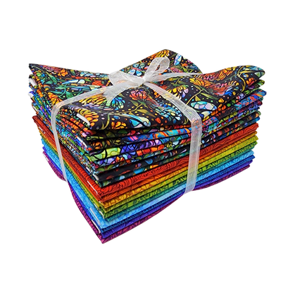 A stack of colorful fabric swatches featuring stained-glass floral designs tied with a white ribbon.