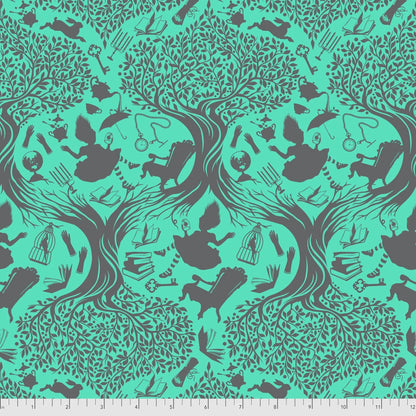 Patterned fabric with a teal toile design of Alice falling into Wonderland. Ruler for scale