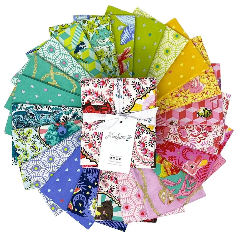 Collection of colorful fabric swatches arranged in a circular pattern with a fat quarter bundle in the center.