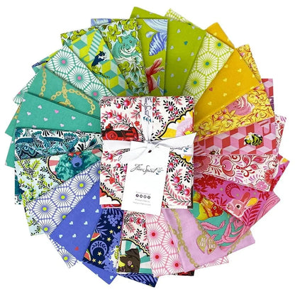 Collection of colorful fabric swatches arranged in a circular pattern with a fat quarter bundle in the center.