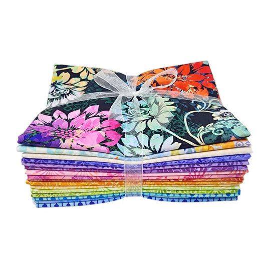 A stack of colorful fabric swatches featuring vibrant floral designs tied with a white ribbon.