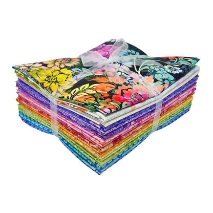 A stack of colorful fabric swatches featuring vibrant floral designs tied with a white ribbon.