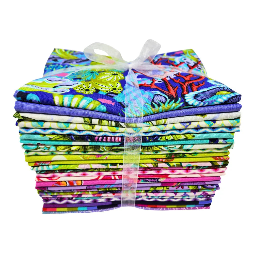 Bundle of colorful fabric pieces tied with a ribbon on a white background