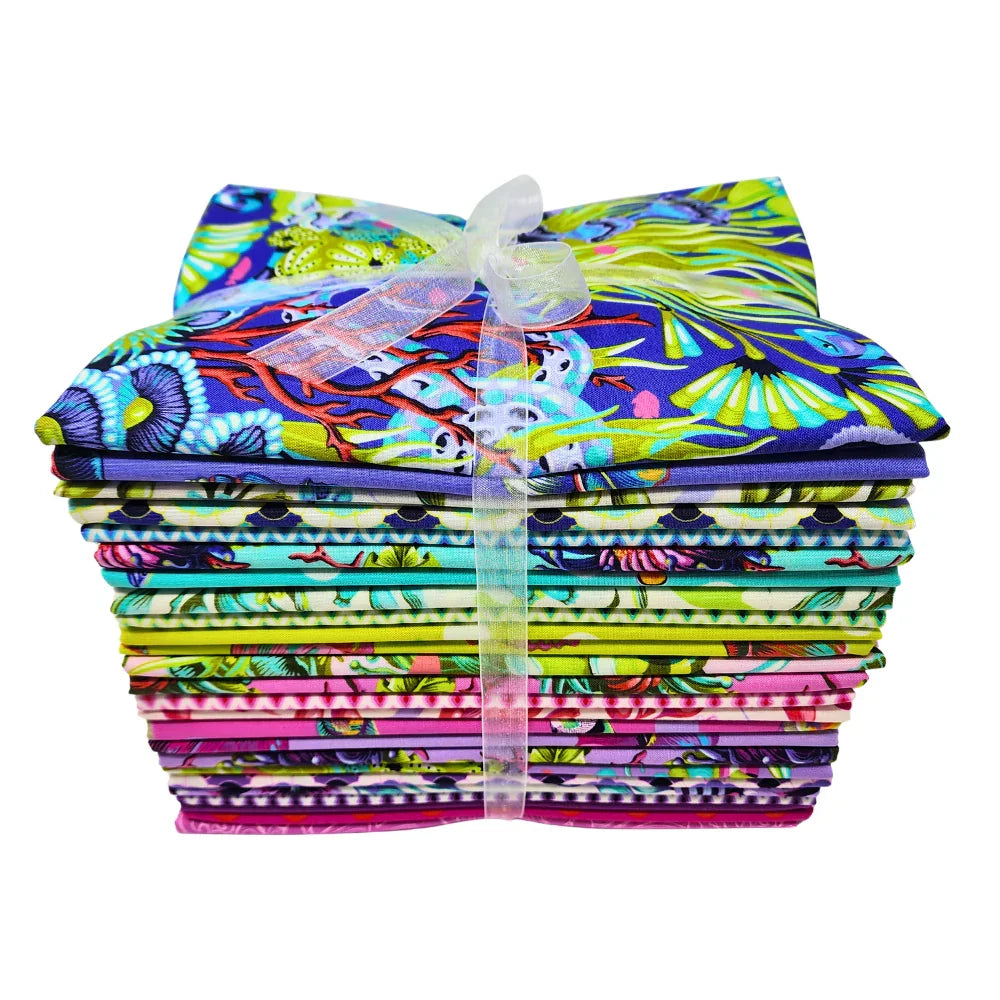 Stack of colorful fabric pieces tied with a white ribbon on a white background