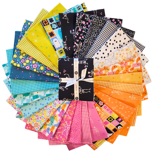 A fanned-out bundle of colorful fabric squares in vivid pinks, oranges, lime-greens, teals, and blacks, featuring Halloween motifs.