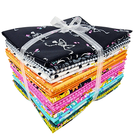 Bundle of colorful fabric squares tied with a ribbon on a white background