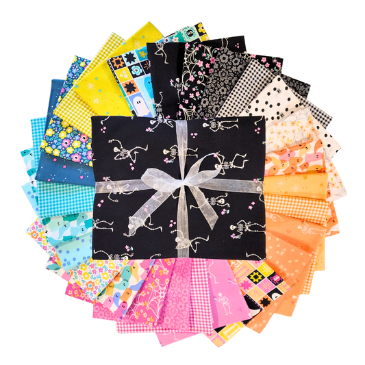 Collection of colorful fabric squares arranged in a circle with a central bundle tied with ribbon