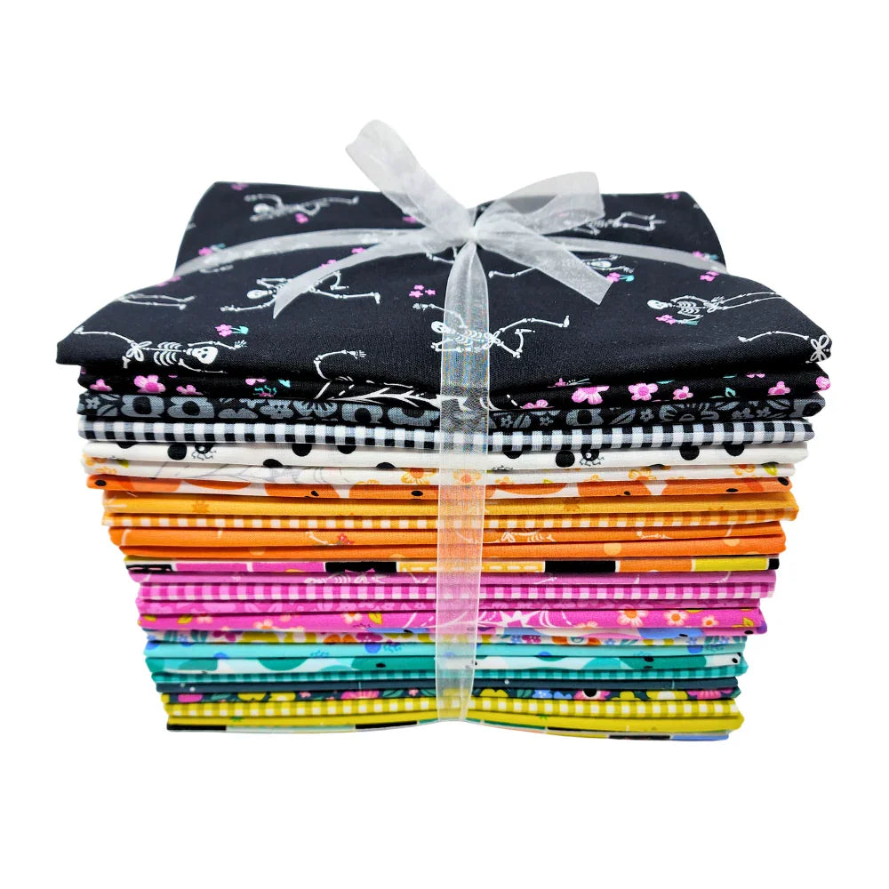 Stack of colorful fabric pieces tied with a white ribbon on a white background