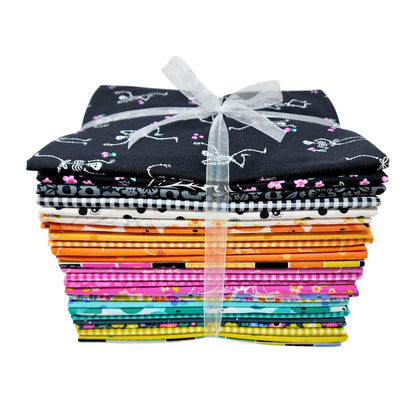 Stack of colorful fabric pieces tied with a white ribbon on a white background