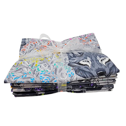 Stack of fabric squares with animal and floral designs tied with a white ribbon on a white background