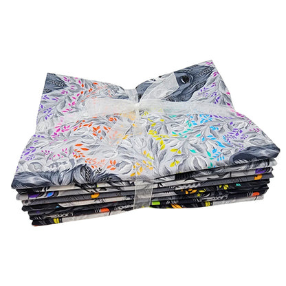 Stack of fabric squares with floral and animal patterns on a white background