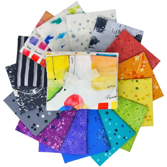 Circular arrangement of patterned fabric swatches in a full rainbow spectrum  with a bundle tied with a white ribbon in the center.