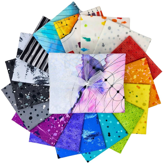 A circular arrangement of colorful patterned fabric squares with a central fabric bundle tied with a sheer white ribbon, all on a plain white background.