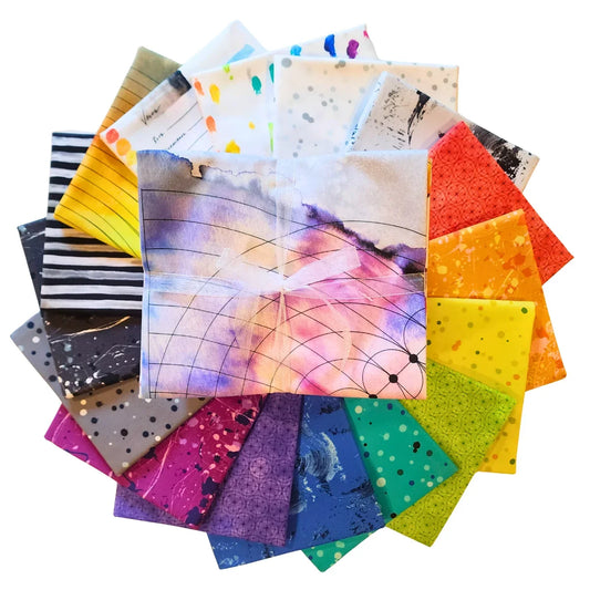 A circular arrangement of colorful patterned fabric squares with a central fabric bundle tied with a sheer white ribbon, all on a plain white background.