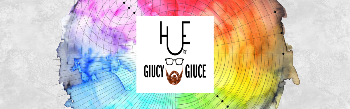 A square white logo card centered over a circular, watercolor-style color wheel with blue, purple, pink, orange, and yellow tones on a light grey textured background. The logo reads 'HUE by GIUCY GIUCE'.