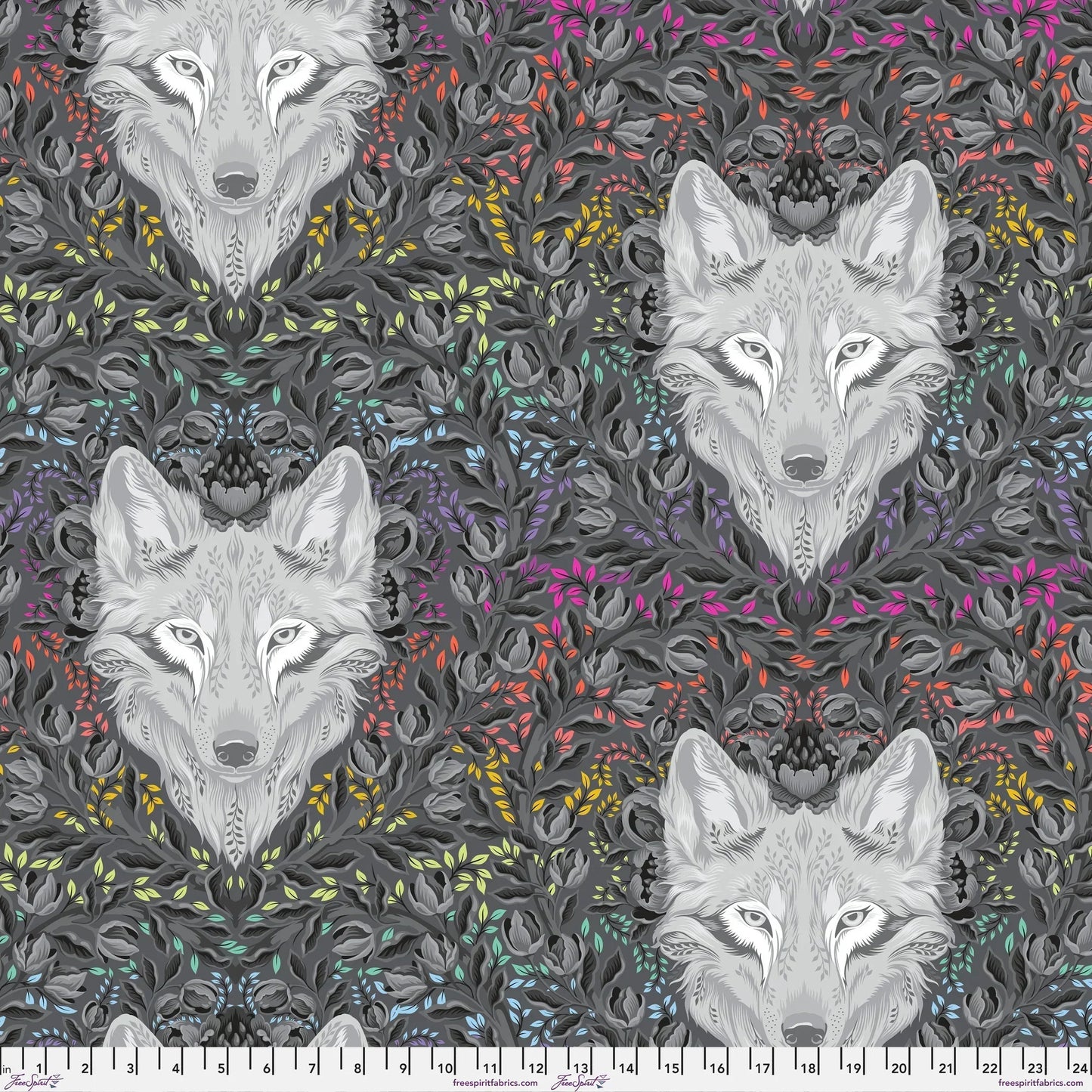 Pattern of wolf faces surrounded by colorful foliage on a dark background with a ruler at the bottom for scale