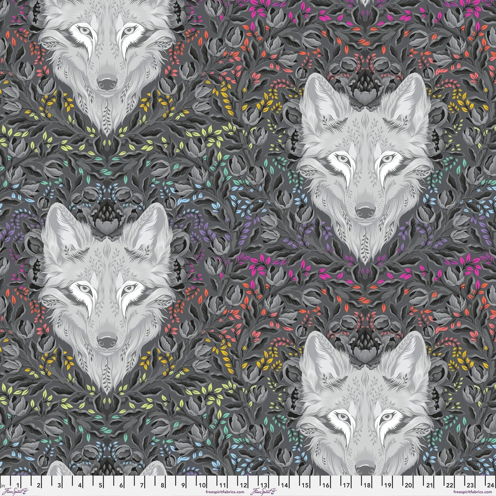 Pattern of wolf faces surrounded by colorful foliage on a dark background with a ruler at the bottom for scale