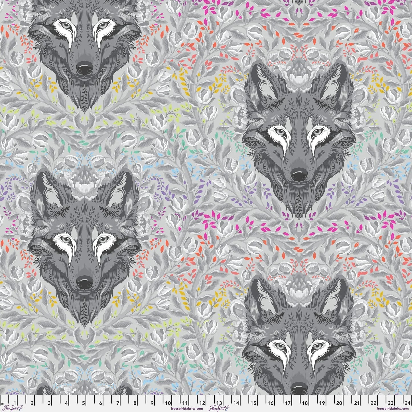 Pattern of wolf heads with colorful foliage on a grey background with a ruler for scale