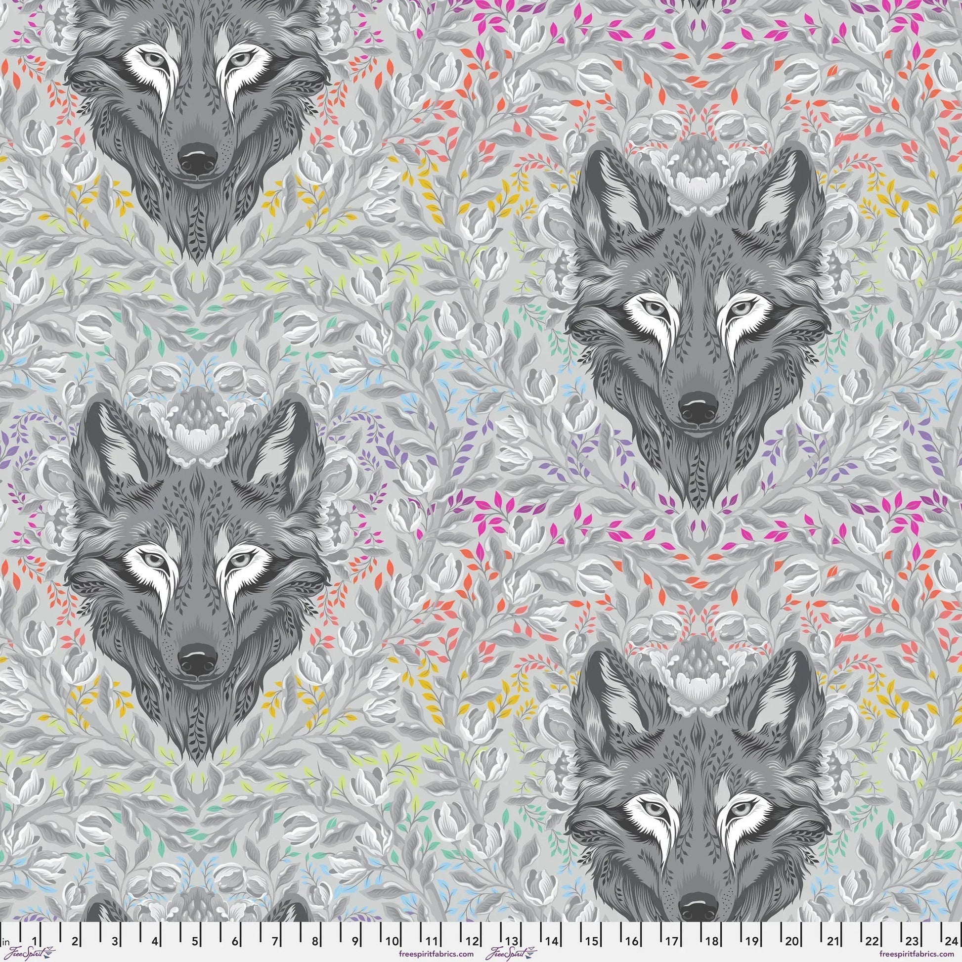 Pattern of wolf heads with colorful foliage on a grey background with a ruler for scale