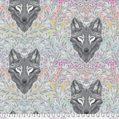 Pattern of wolf heads with colorful foliage on a grey background with a ruler for scale