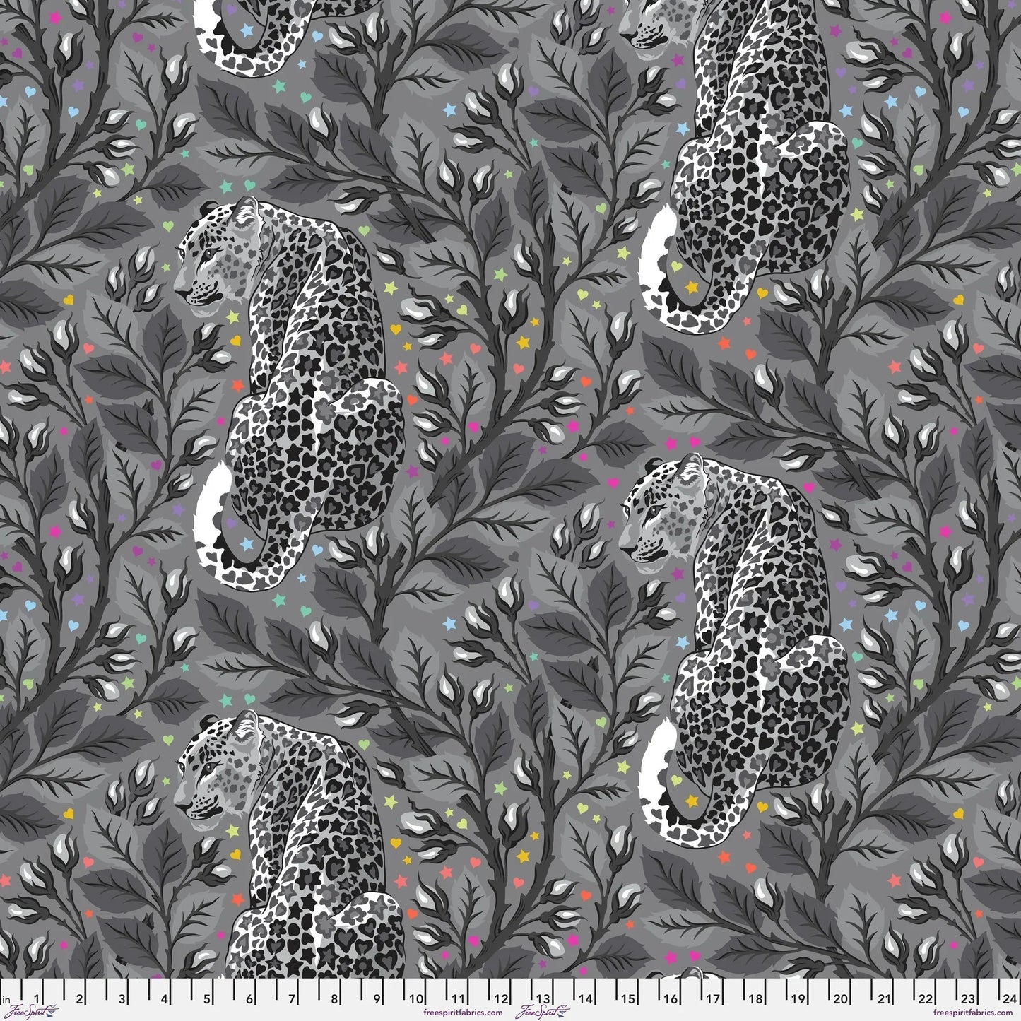 Pattern of leopards and leaves on a gray background dotted with rainbow accents. Ruler for scale