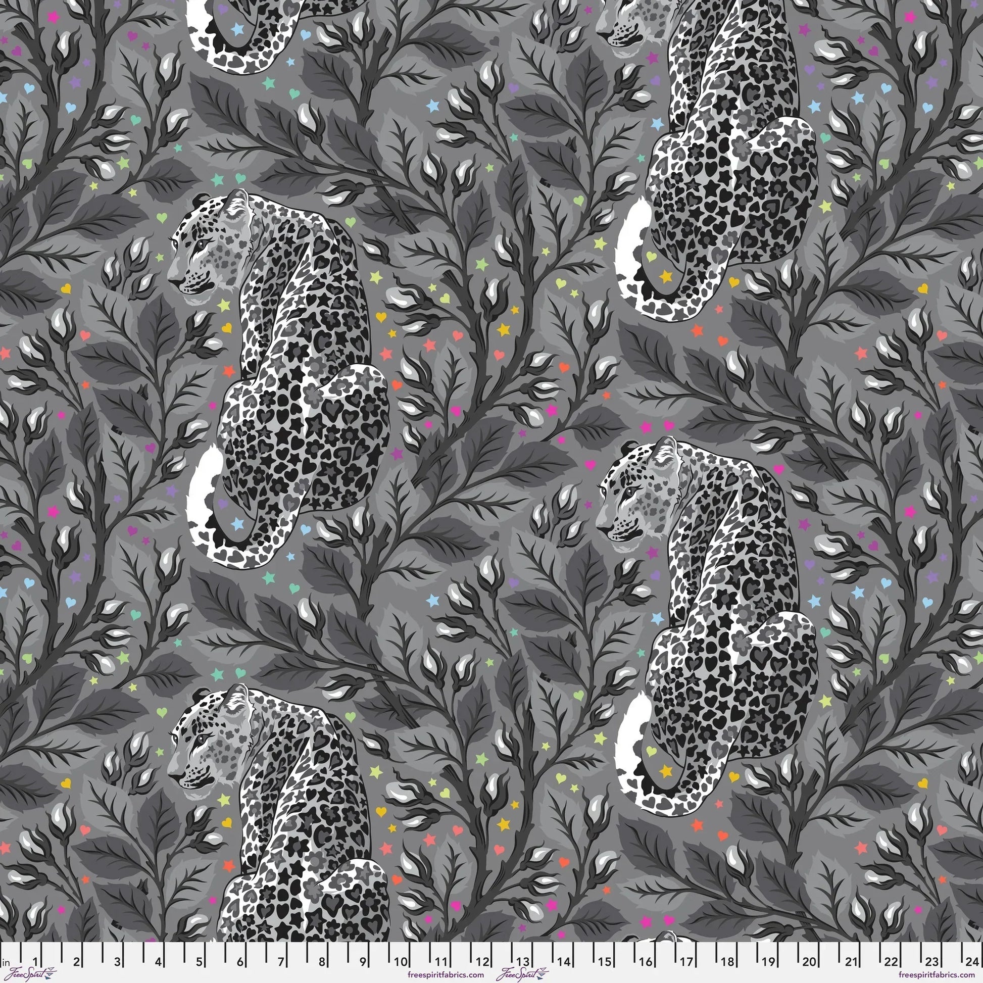 Pattern of leopards and leaves on a gray background dotted with rainbow accents. Ruler for scale