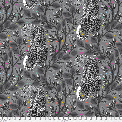 Pattern of leopards and leaves on a gray background dotted with rainbow accents. Ruler for scale