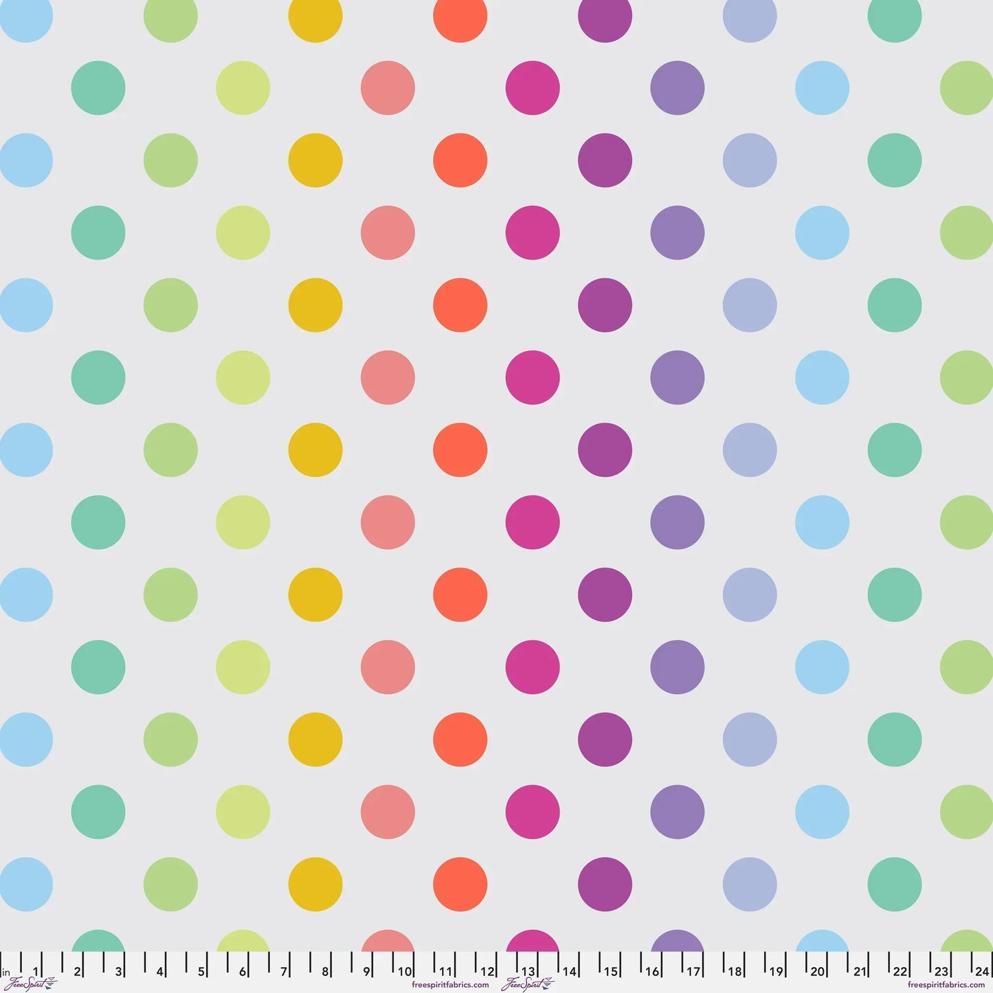 Pattern of colorful polka dots on a light grey background with a ruler at the bottom for scale