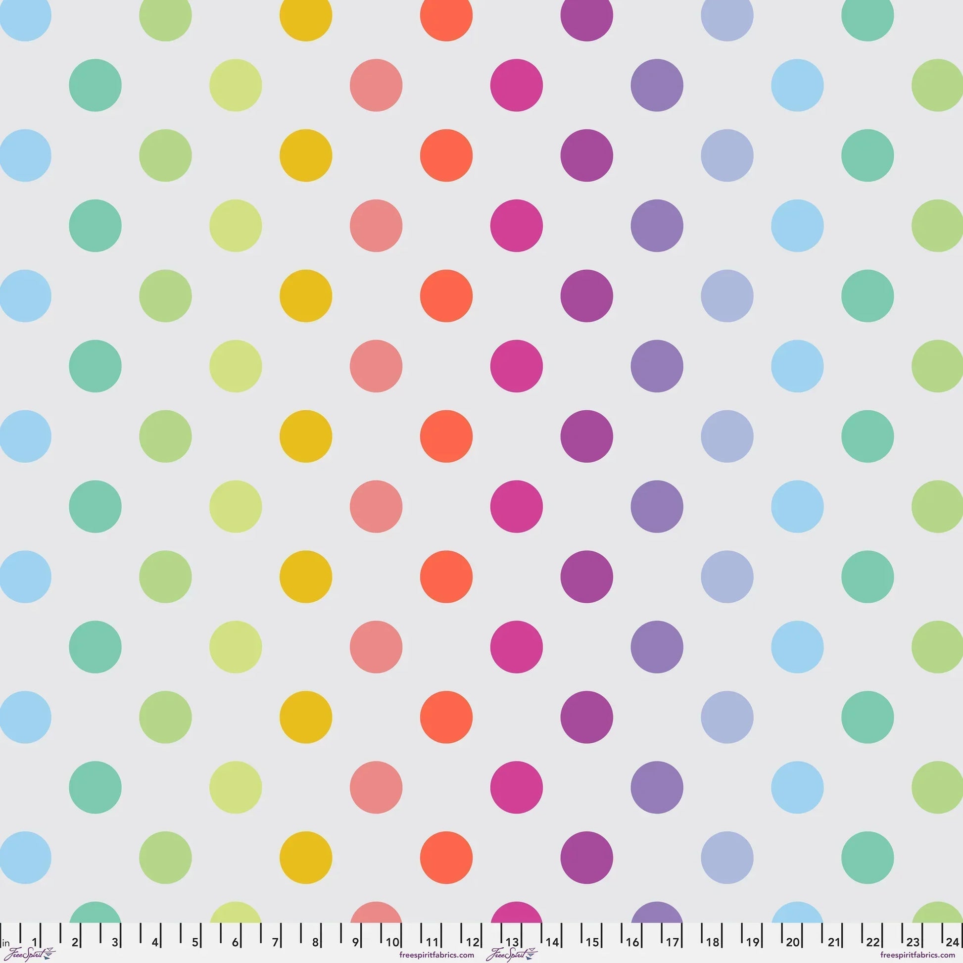 Pattern of colorful polka dots on a light grey background with a ruler at the bottom for scale