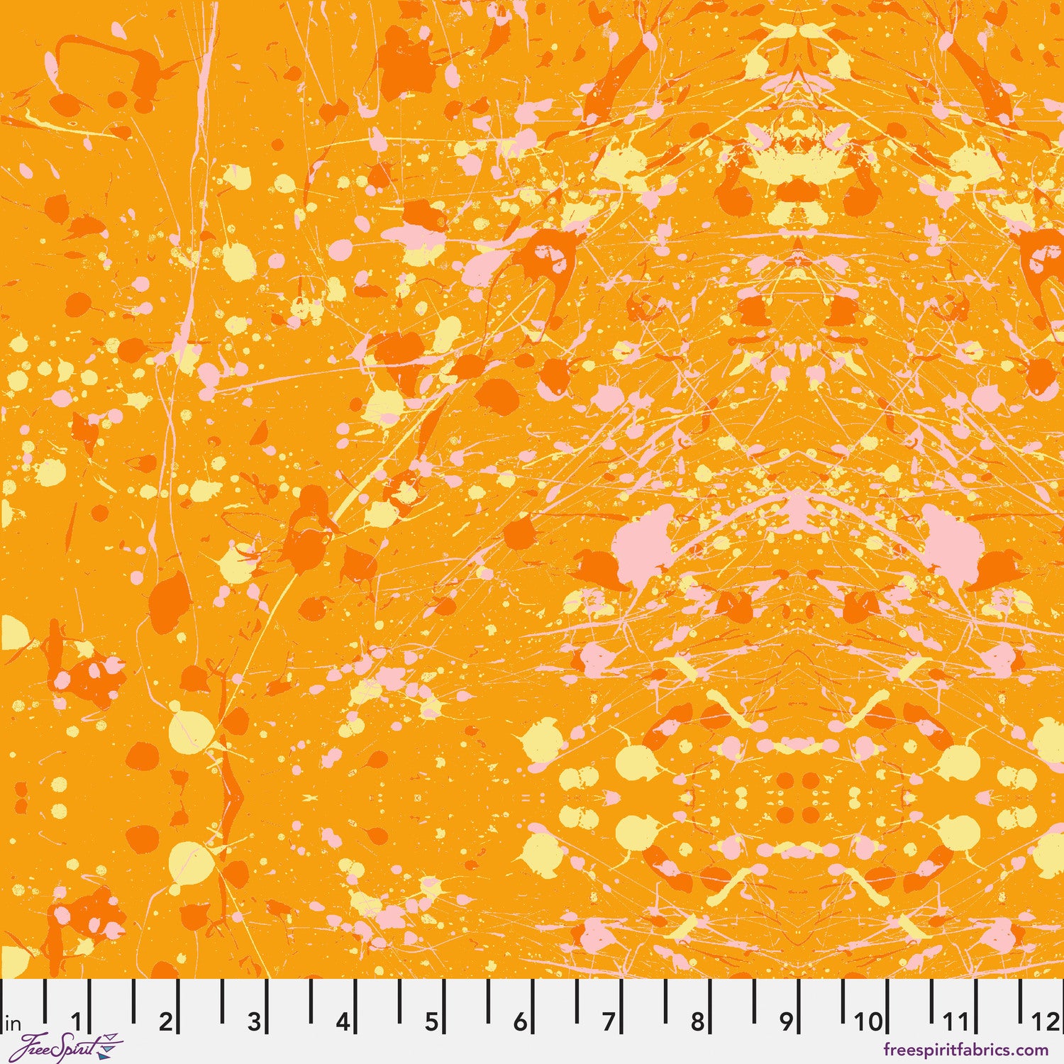 Abstract paint-splatter fabric pattern in bright orange, with scattered pink and yellow splashes and drips. Ruler at the bottom for scale.