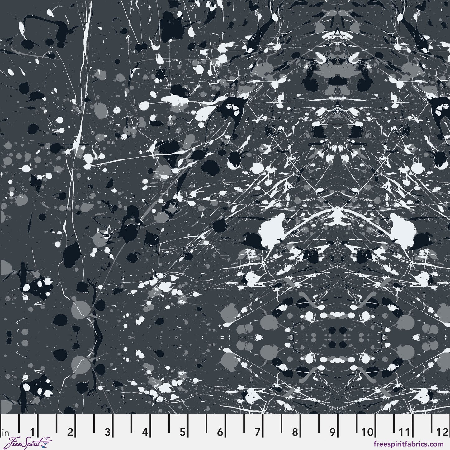 Abstract paint-splatter fabric pattern in charcoal grey, with scattered black and white splashes and drips. Ruler at the bottom for scale.