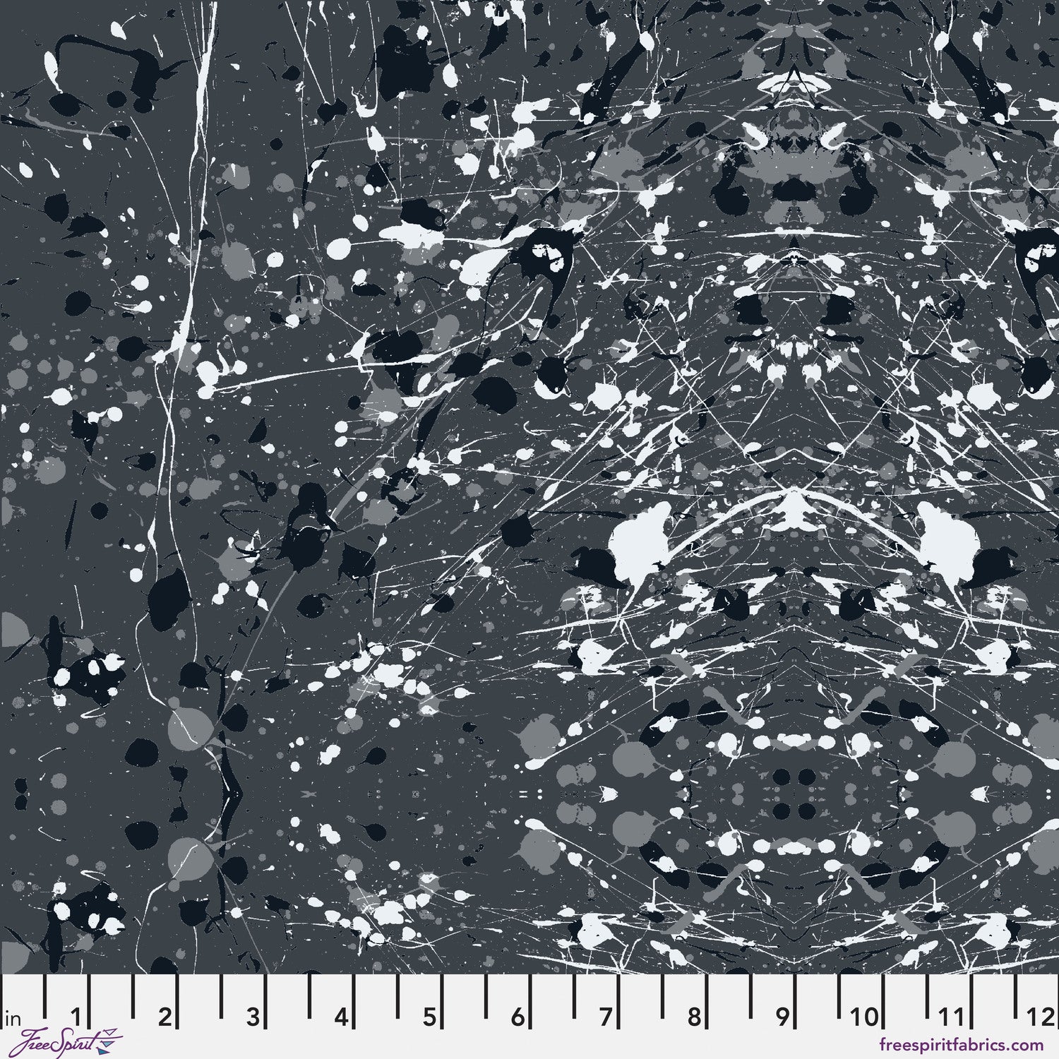 Abstract paint-splatter fabric pattern in charcoal grey, with scattered black and white splashes and drips. Ruler at the bottom for scale.